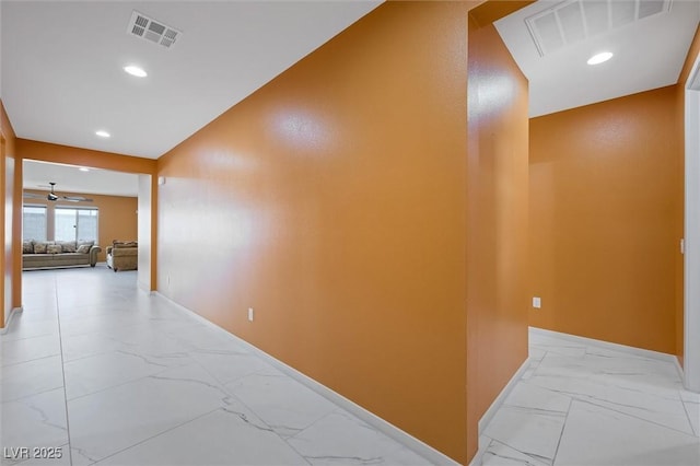 corridor featuring recessed lighting, baseboards, visible vents, and marble finish floor