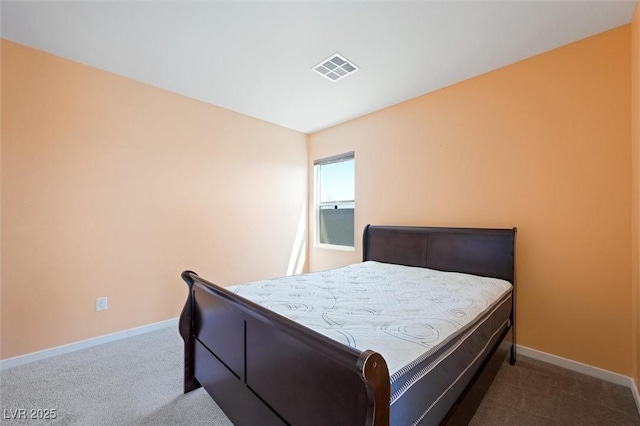carpeted bedroom featuring baseboards and visible vents