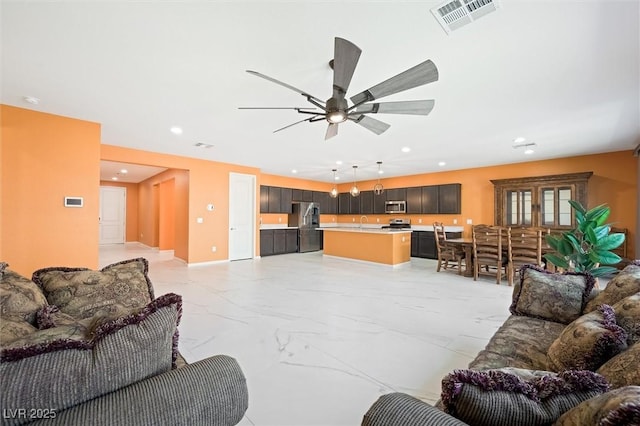 living room with ceiling fan, visible vents, baseboards, marble finish floor, and recessed lighting