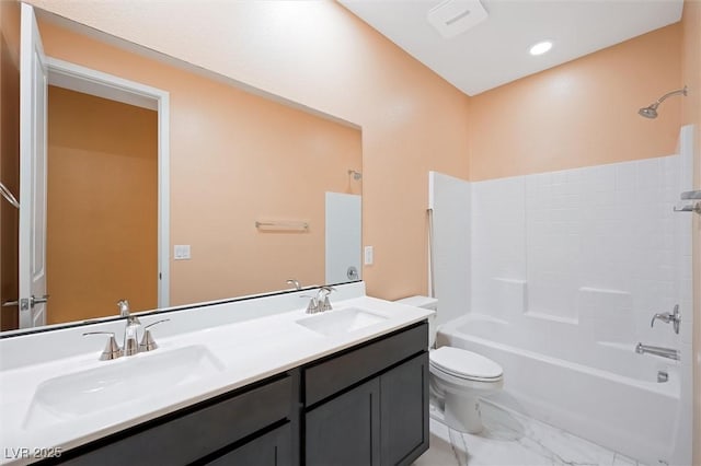 full bathroom with a sink, washtub / shower combination, toilet, and marble finish floor