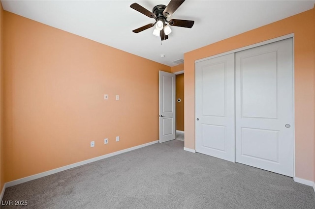 unfurnished bedroom featuring a closet, baseboards, a ceiling fan, and carpet flooring