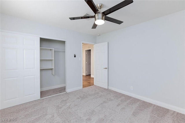 unfurnished bedroom featuring baseboards, a ceiling fan, carpet, and a closet