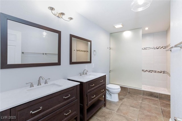 bathroom with a sink, walk in shower, two vanities, and toilet