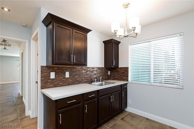 kitchen with light tile patterned floors, tasteful backsplash, and dark brown cabinets