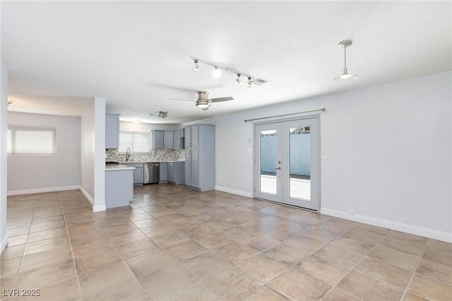 unfurnished living room featuring ceiling fan, visible vents, plenty of natural light, and french doors