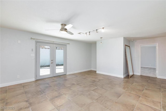 spare room with visible vents, baseboards, rail lighting, french doors, and a ceiling fan
