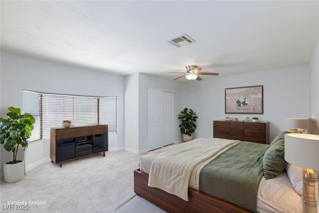 bedroom with visible vents, carpet floors, a closet, baseboards, and ceiling fan