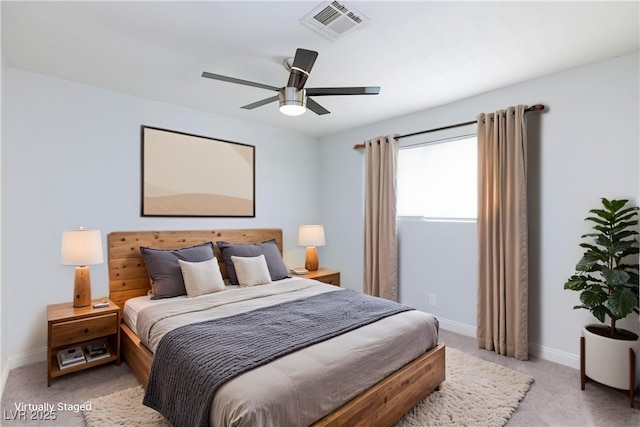 bedroom with visible vents, baseboards, and light colored carpet