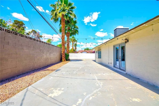 view of patio featuring a fenced backyard and driveway
