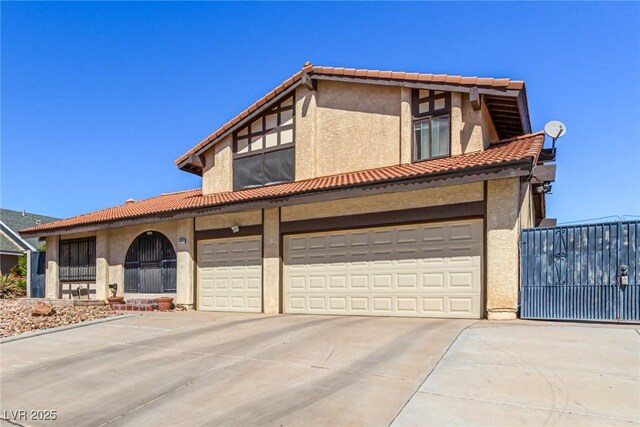 view of front facade featuring an attached garage, stucco siding, driveway, and a tile roof