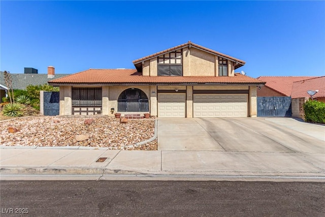 view of front of home with a garage, stucco siding, concrete driveway, and a tile roof