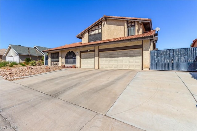 view of front of house featuring a garage, stucco siding, concrete driveway, and a tile roof