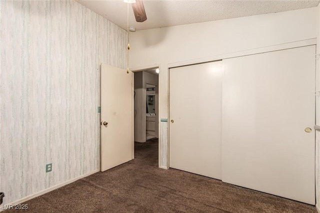 unfurnished bedroom featuring a ceiling fan, carpet, and a closet