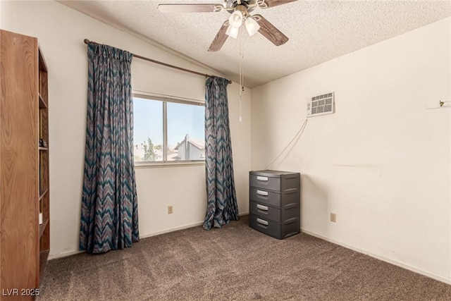 unfurnished bedroom with vaulted ceiling, ceiling fan, carpet flooring, and a textured ceiling