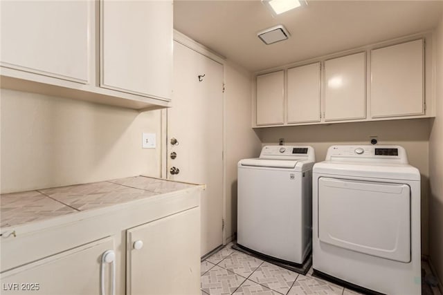 laundry area featuring cabinet space and washing machine and dryer