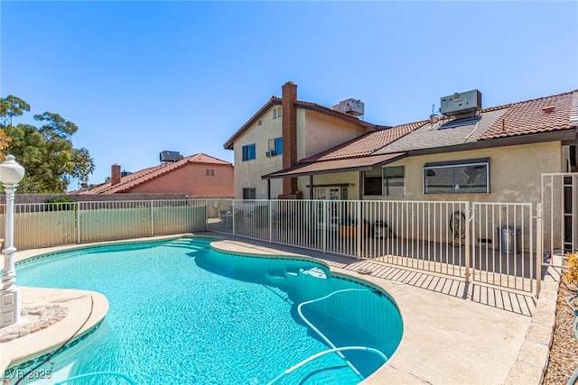 view of swimming pool with a patio, central AC, fence, and a fenced in pool