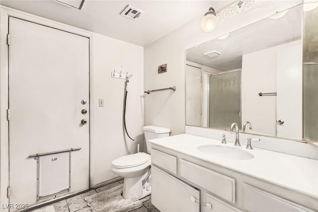full bathroom featuring vanity, a shower with shower door, toilet, and visible vents