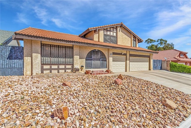 view of front of house with fence, stucco siding, an attached garage, driveway, and a tile roof