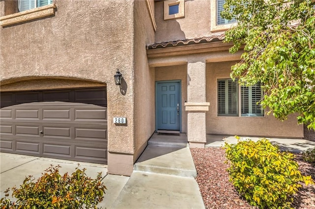 260 Pioneers Peak, Henderson, NV 89002 - view of exterior entry featuring stucco siding and an attached garage