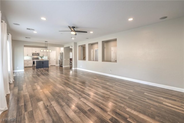 260 Pioneers Peak, Henderson, NV 89002 - unfurnished living room with visible vents, dark wood-type flooring, baseboards, ceiling fan, and recessed lighting