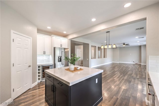 260 Pioneers Peak, Henderson, NV 89002 - kitchen featuring beverage cooler, visible vents, light countertops, white cabinets, and high end refrigerator