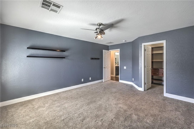 260 Pioneers Peak, Henderson, NV 89002 - unfurnished bedroom featuring visible vents, carpet floors, baseboards, a spacious closet, and a textured wall