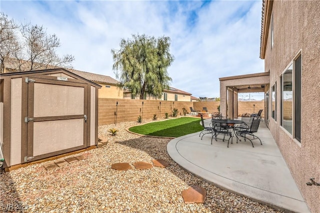 260 Pioneers Peak, Henderson, NV 89002 - view of yard featuring a storage unit, an outbuilding, a fenced backyard, and a patio area