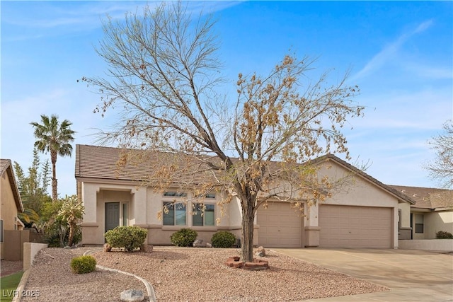 view of front of house with concrete driveway, stucco siding, and an attached garage