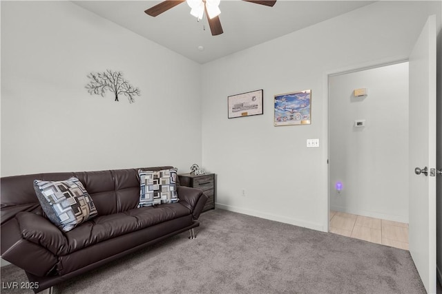 living area featuring baseboards, carpet floors, and a ceiling fan