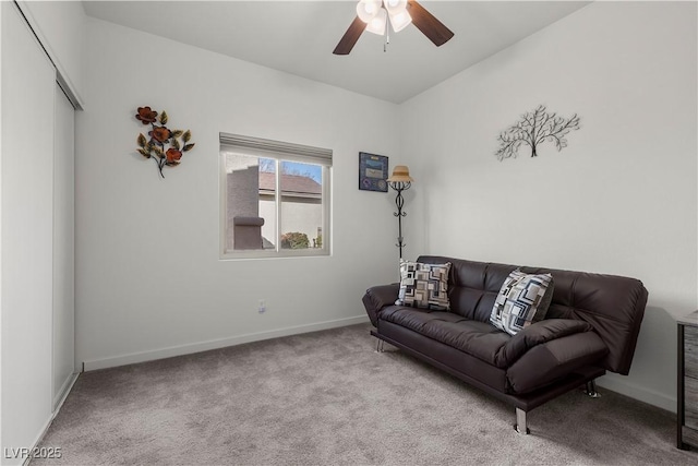 carpeted living room with baseboards and a ceiling fan