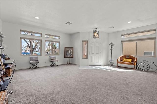 carpeted entryway featuring baseboards, visible vents, and recessed lighting