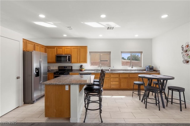kitchen with a kitchen island, visible vents, recessed lighting, and stainless steel appliances