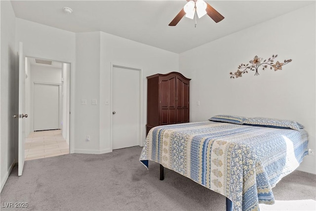 carpeted bedroom with visible vents and ceiling fan
