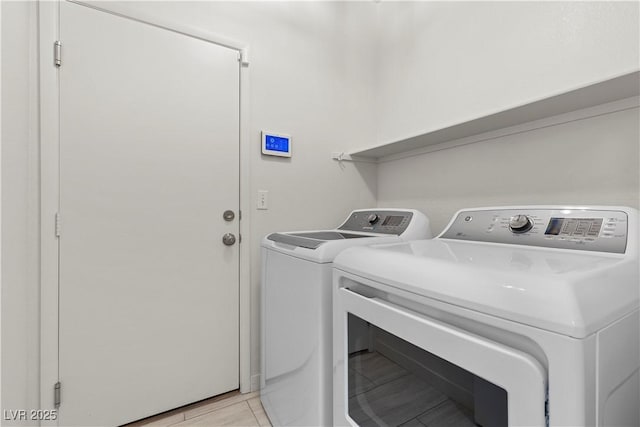 laundry room with washing machine and clothes dryer and laundry area