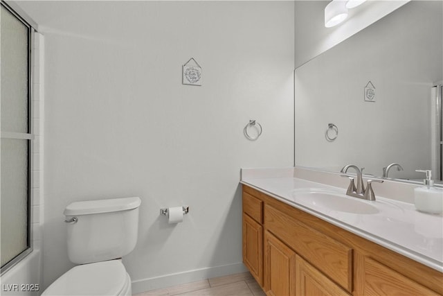 bathroom featuring baseboards, toilet, and vanity