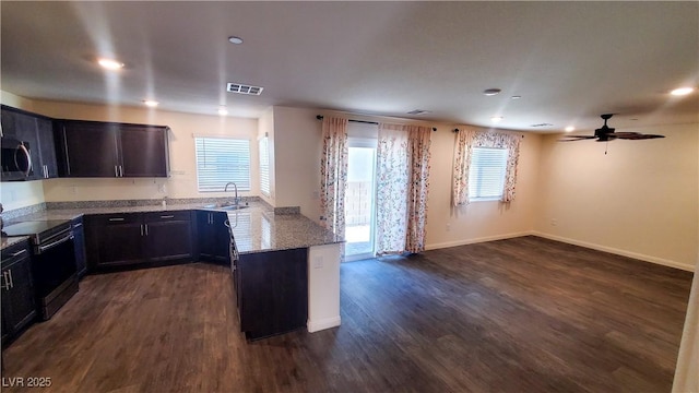 2765 Frosted Teal Ave, North Las Vegas, NV 89086 - kitchen featuring electric range, light stone counters, a peninsula, dark wood-type flooring, and recessed lighting