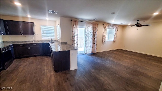 2765 Frosted Teal Ave, North Las Vegas, NV 89086 - kitchen with a sink, light stone counters, dark wood-type flooring, black range with electric cooktop, and a ceiling fan