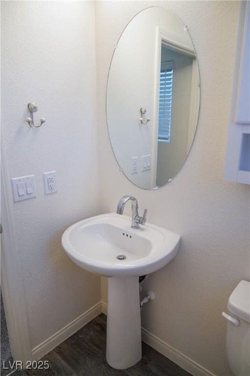 2765 Frosted Teal Ave, North Las Vegas, NV 89086 - bathroom featuring baseboards, wood finished floors, and toilet