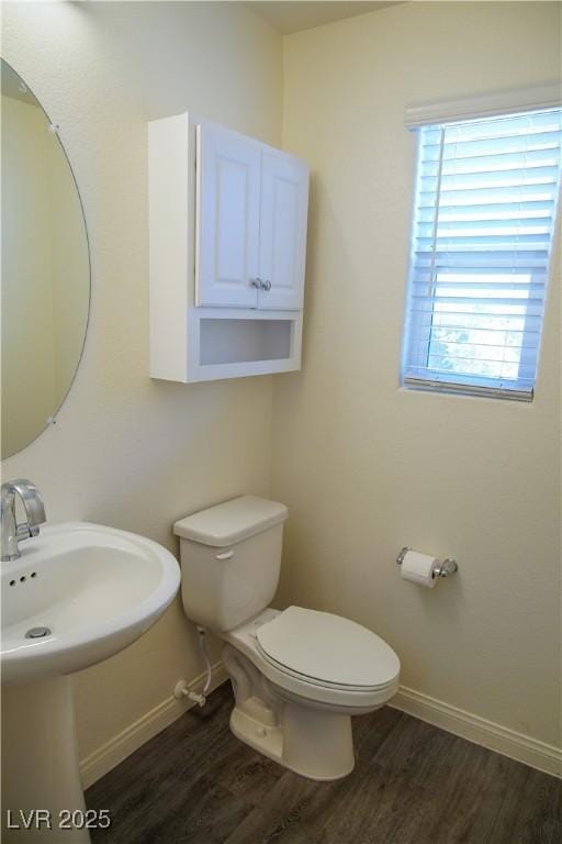 2765 Frosted Teal Ave, North Las Vegas, NV 89086 - bathroom with baseboards, toilet, wood finished floors, and a sink