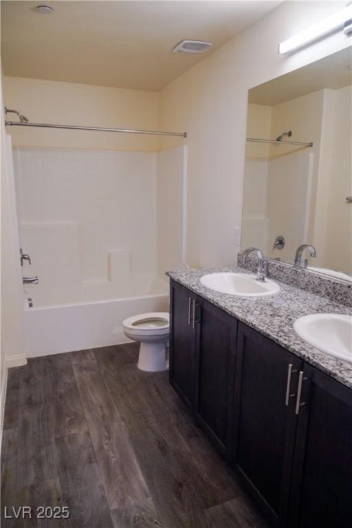 2765 Frosted Teal Ave, North Las Vegas, NV 89086 - bathroom featuring bathtub / shower combination, wood finished floors, toilet, and double vanity