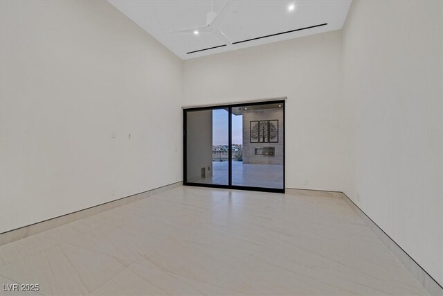 empty room featuring a high ceiling and recessed lighting