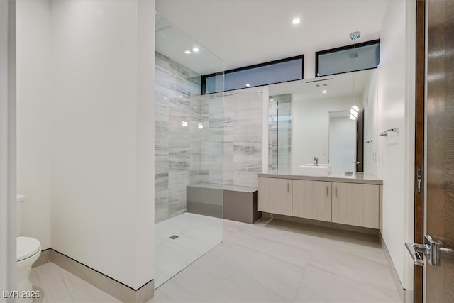bathroom with walk in shower, vanity, recessed lighting, and toilet