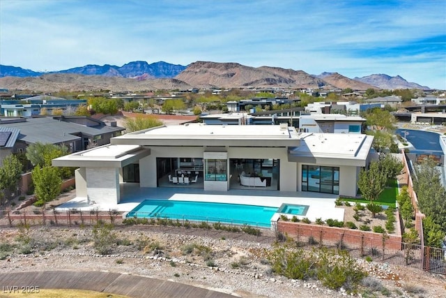 back of property with fence private yard, a patio area, stucco siding, and a mountain view