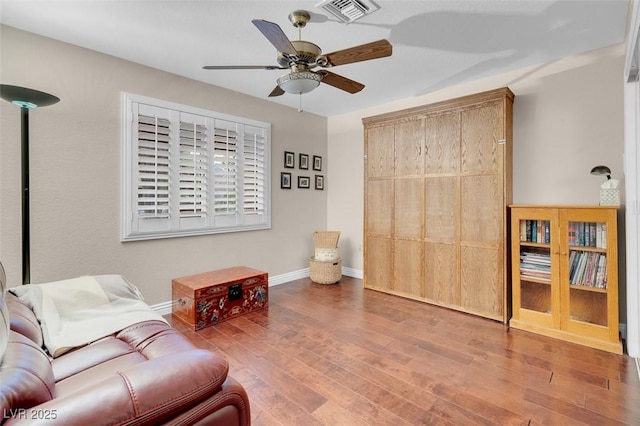sitting room with visible vents, baseboards, a ceiling fan, and wood finished floors