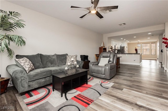 10091 Sand Key St, Las Vegas, NV 89178 - living room featuring wood finished floors, a ceiling fan, baseboards, and recessed lighting