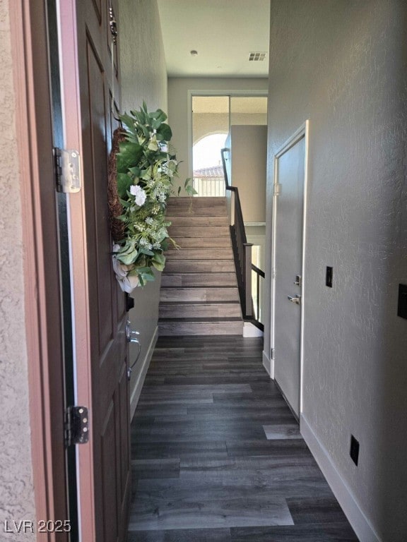 10091 Sand Key St, Las Vegas, NV 89178 - stairs with a textured wall, wood finished floors, and baseboards