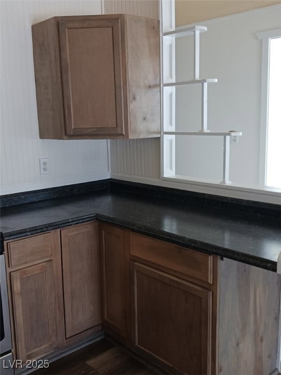 kitchen with a wealth of natural light, dark countertops, and dark wood-style flooring