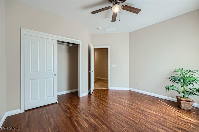 unfurnished bedroom featuring a closet, baseboards, wood finished floors, and a ceiling fan