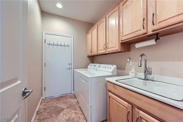 laundry area featuring recessed lighting, a sink, cabinet space, and separate washer and dryer