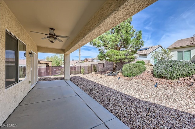 view of patio with fence and ceiling fan
